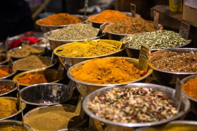 Assorted whole and ground spices at a market